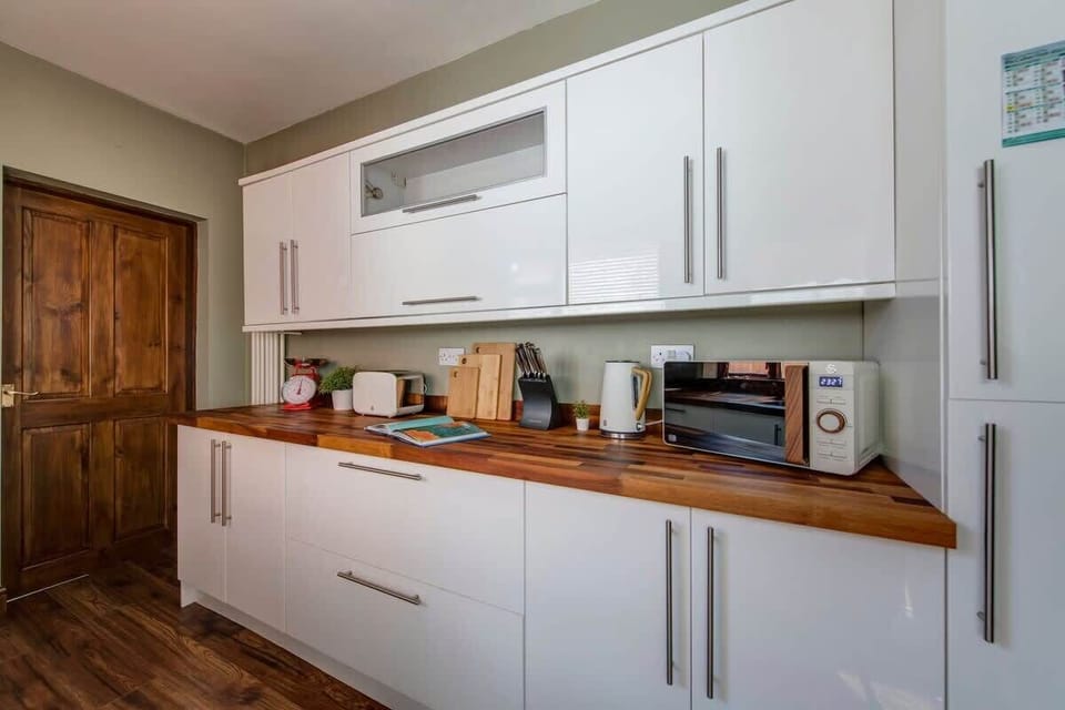 "Cook and dine in this fully equipped, spotless kitchen—featuring modern appliances, ample counter space, and everything you need to prepare your favorite meals."