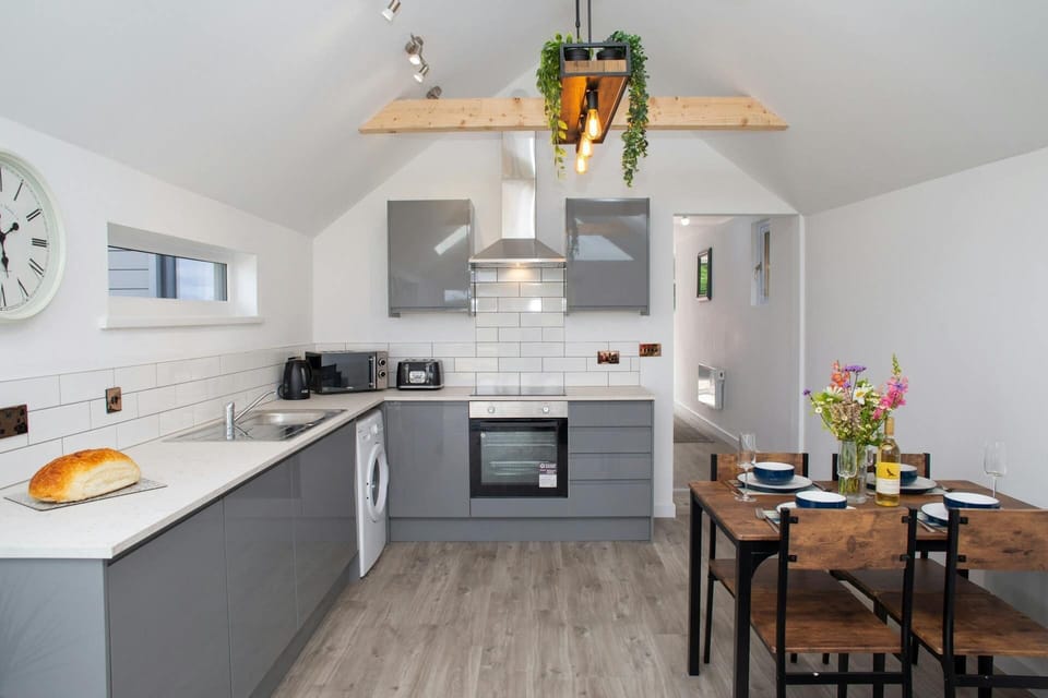 Kitchen area with microwave, electric hob and oven