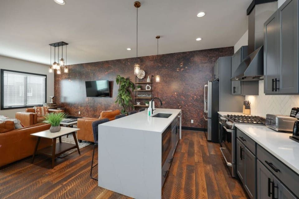 The vinyl record collection displayed on the wall is a nod to this home`s deep music-city soul.