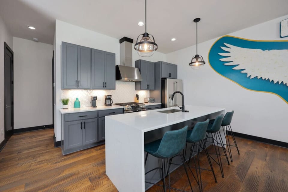 The kitchen island with teal barstools is perfect for casual meals.