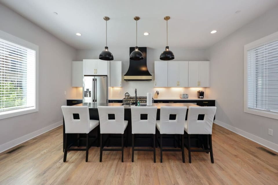 Kitchen wide view showing island, appliances, and open floor plan