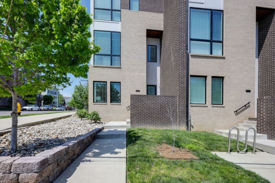 Exterior of modern multi-story home with stone and brick facade and contemporary architecture