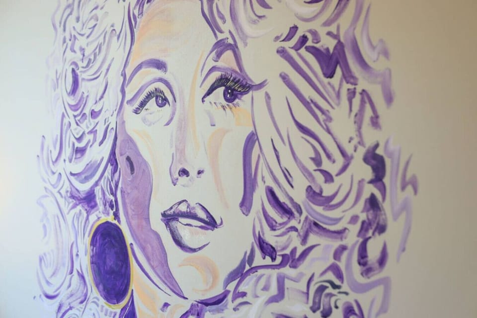 Stunning purple mural portrait adding dramatic artistic flair to the bedroom space