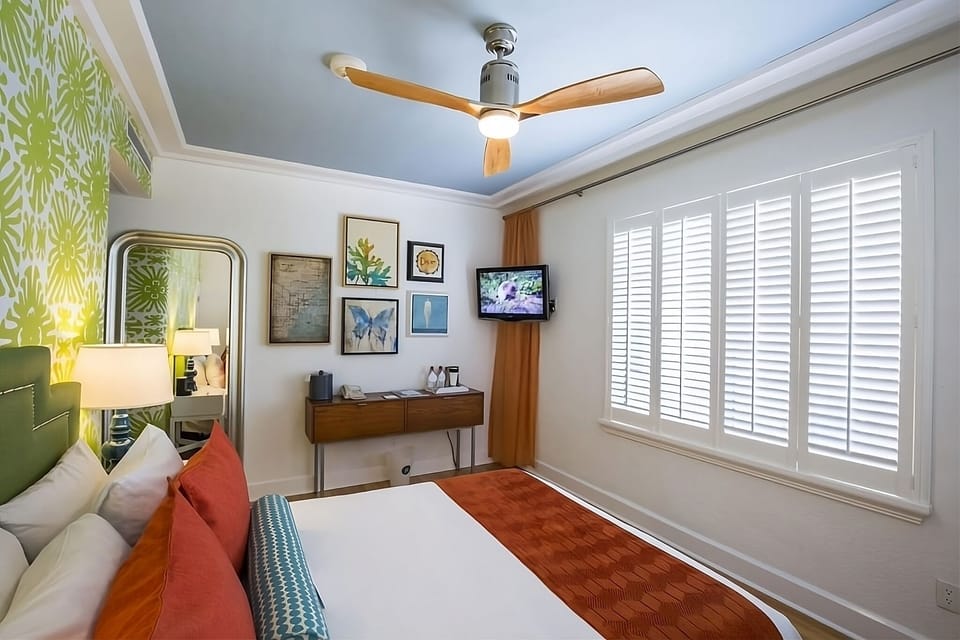 Recharge in crisp linens framed by bright, cheerful decor.