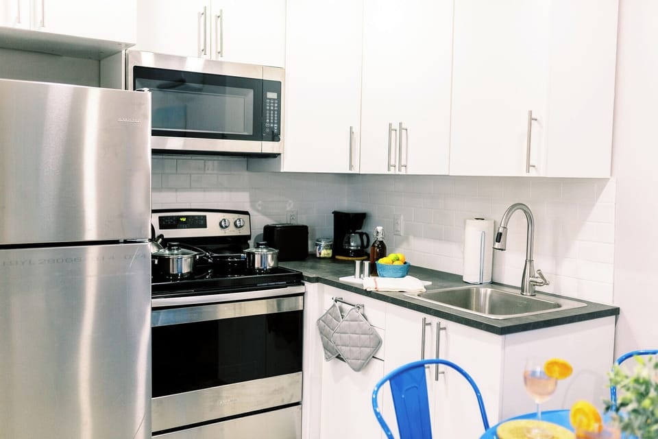 Step into culinary delight in our modern kitchen, where style meets functionality. Immerse yourself in the art of cooking surrounded by sleek design and top-notch appliances—a perfect space for creating delicious memories.