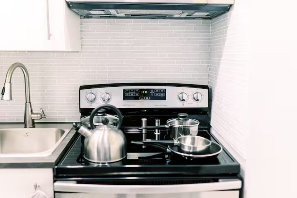 Experience culinary delight in our well-appointed kitchen, where a modern stove, microwave, fridge, and sink await. A harmonious blend of functionality and sophistication, offering the perfect space to create delicious moments and lasting memories.