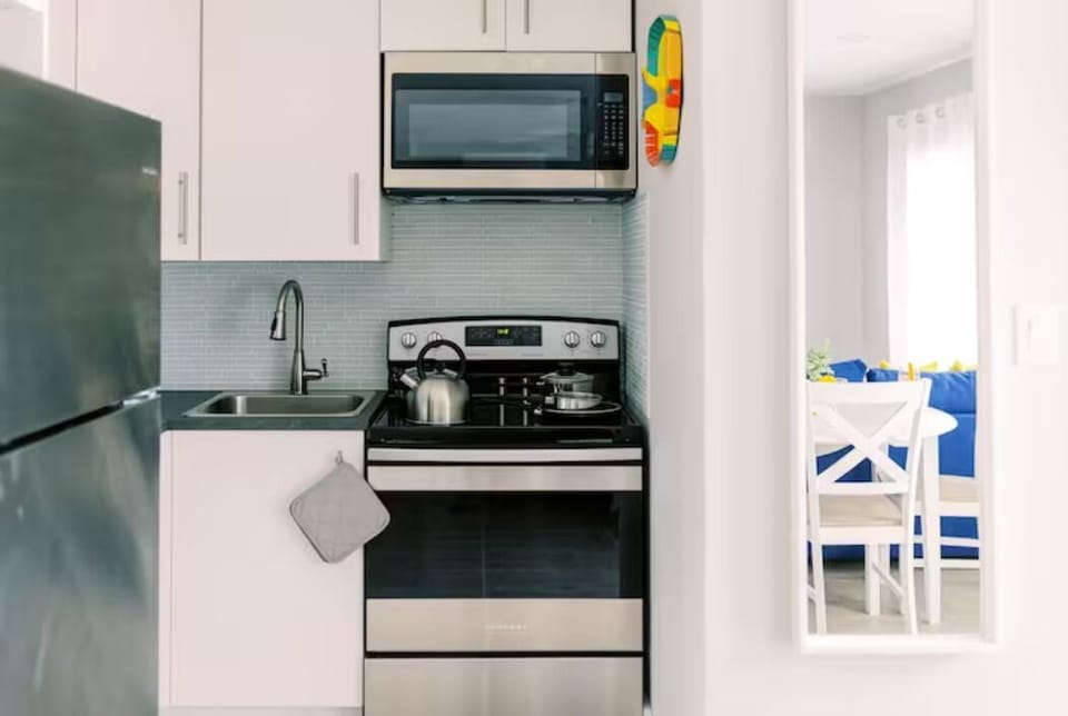 Experience culinary delight in our well-appointed kitchen, where a modern stove, microwave, fridge, and sink await. A harmonious blend of functionality and sophistication, offering the perfect space to create delicious moments and lasting memories.