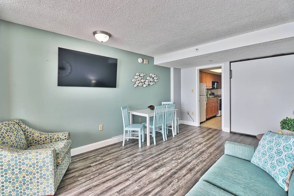 Embrace the serene ambiance of the oceanfront living area, where comfortable seating invites you to unwind while taking in panoramic views of the sea.
