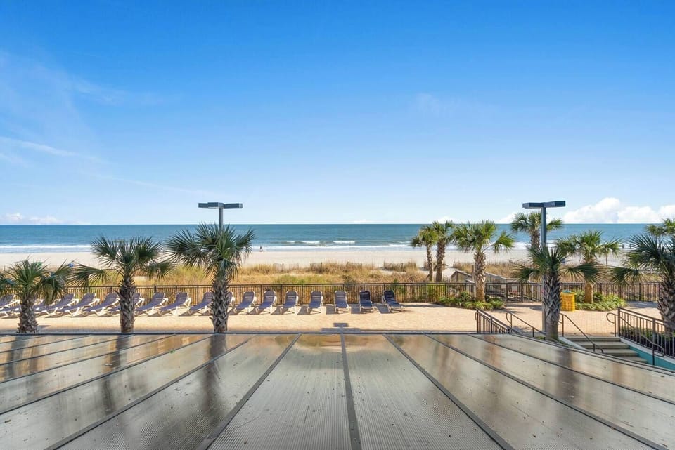 Take a dip in a sparkling pool with direct views of the ocean, providing a refreshing retreat just steps away from your accommodation.