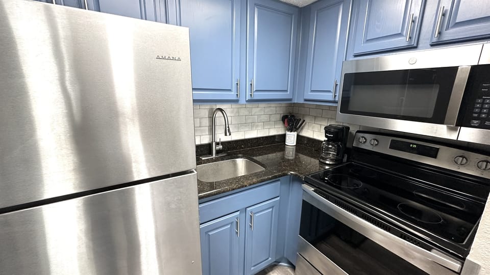 Experience the elegance of an open-concept kitchen in our suite, where stylish design seamlessly merges with functionality to create a sophisticated cooking space.