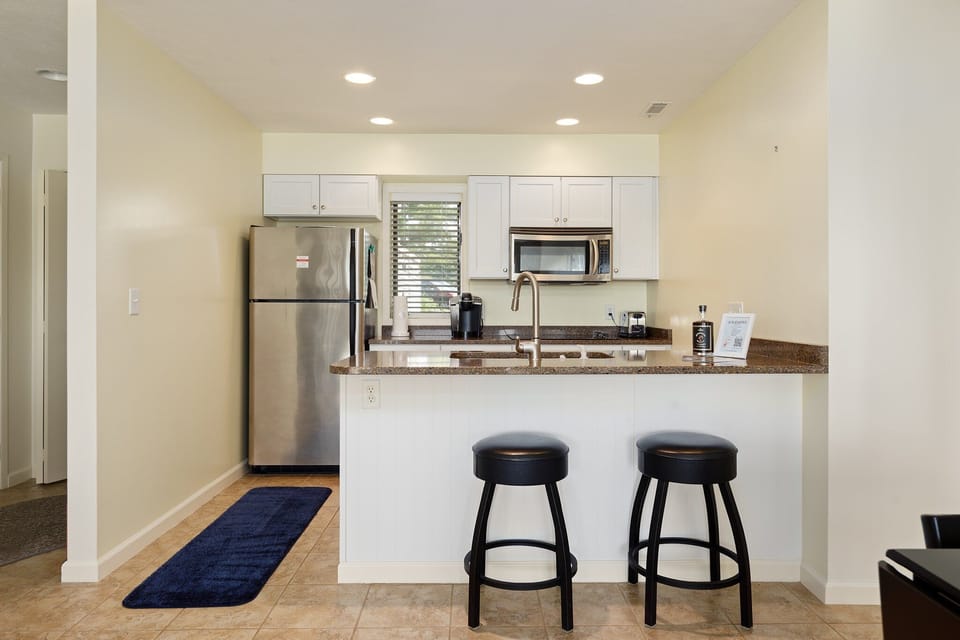Functional kitchen layout w/ island seating & plenty of counter space for prep.