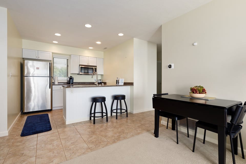 Dining area w/ a sleek table set beside the open kitchen for easy gatherings.