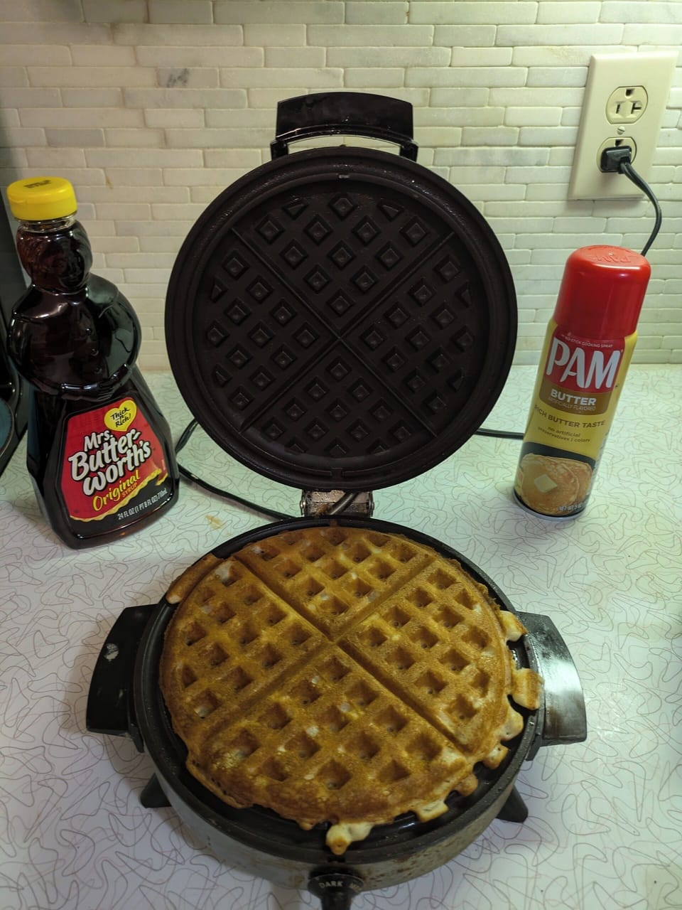 Waffle maker, pancake mix, syrup, cooking spray available for your enjoyment