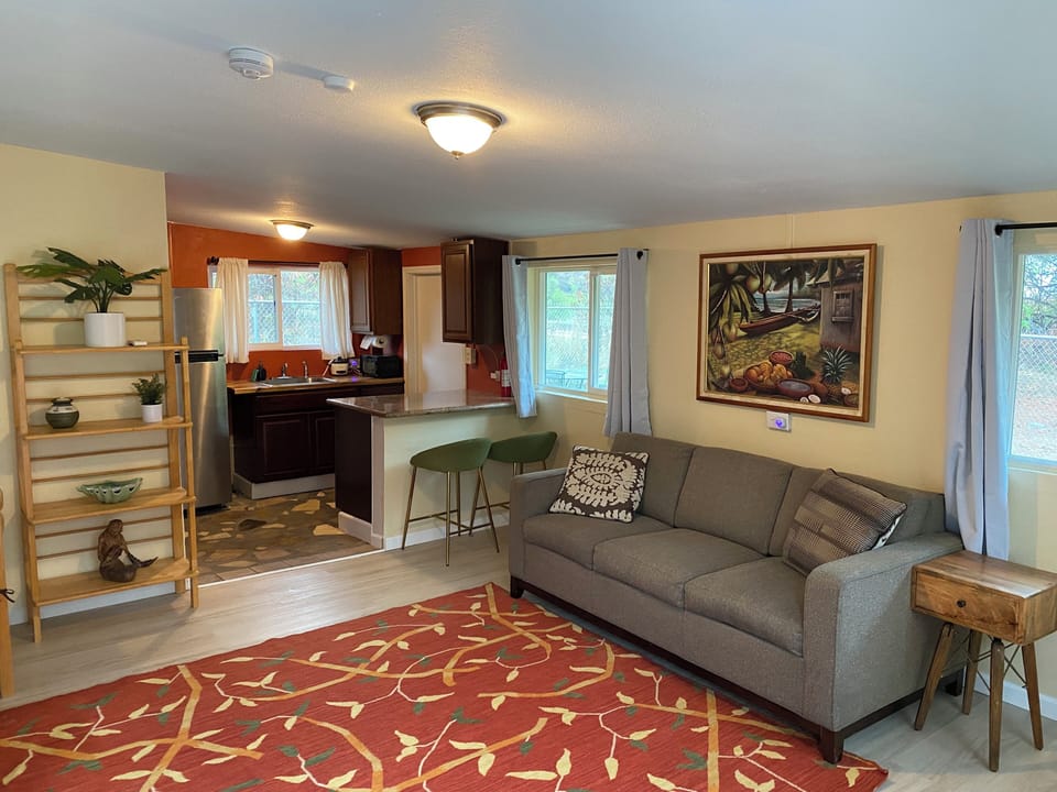 cottage with a full sized pullout couch bed, full bathroom and half kitchen 