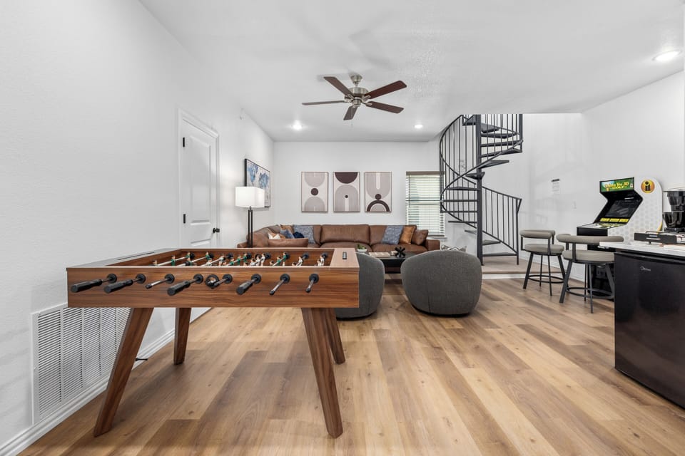 Expansive upstairs living room brimming with games and entertainment, offering the perfect spot for endless fun and memorable gatherings.