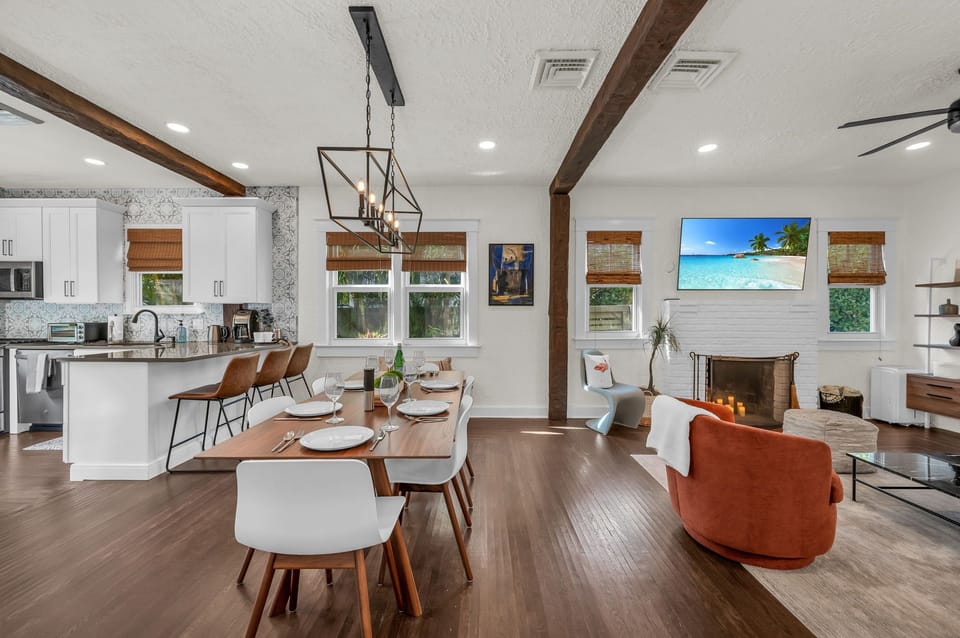 Step into the dining area and experience mid-century elegance under the glow of a beautiful chandelier. The large dining table seats six, while two bar stools at the kitchen counter offer casual seating.