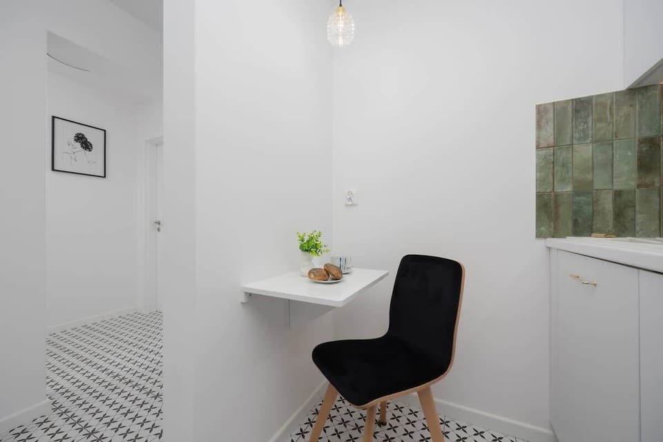 A small dining table with a chair, ideal for enjoying a quick meal or a morning coffee.