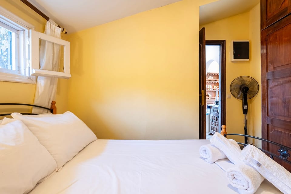 Bedroom 2 Alt • Warm Earthy Quilt & Reading Lamps
