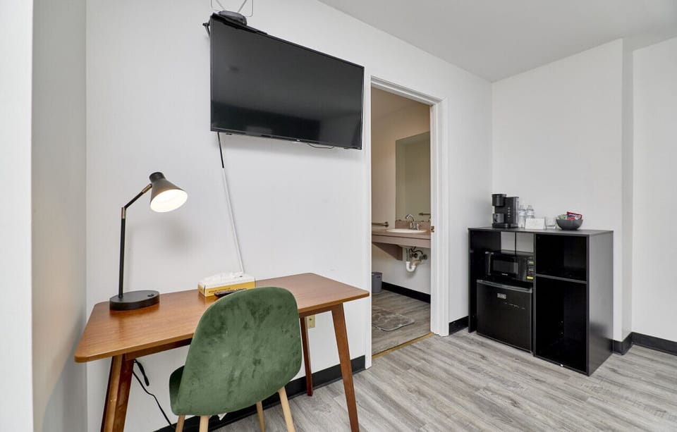Desk with mini fridge, microwave and coffee machine