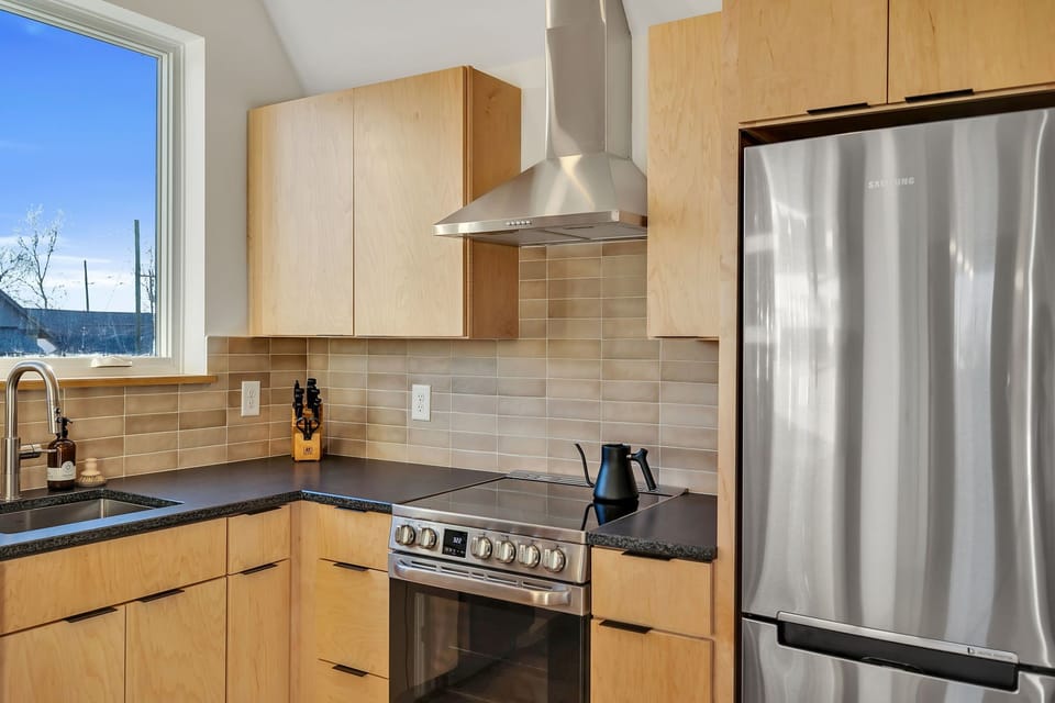 High-end appliances, coffee bar, dishwasher and electric range.