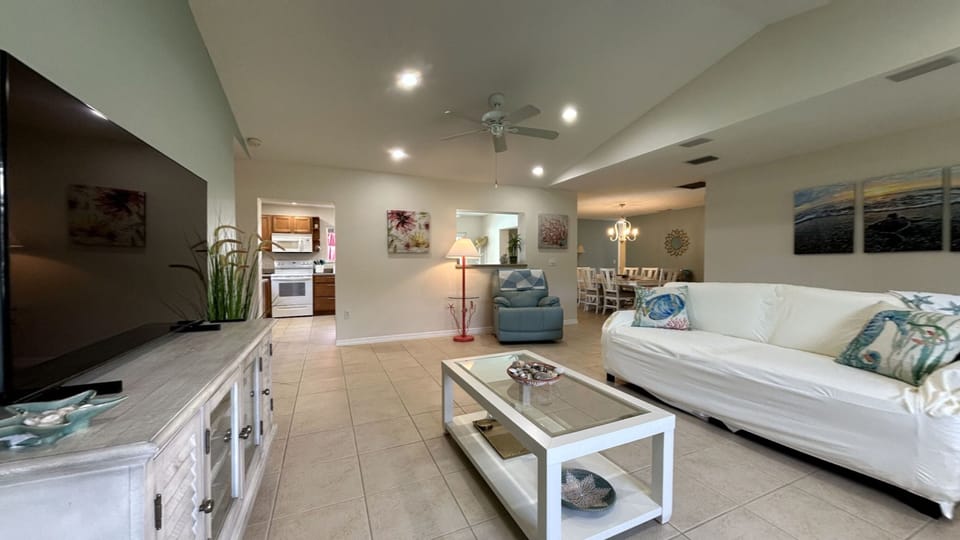 Our living room has comfy sofas,TV,ceiling fans,lamps,and a handy storage bench.
