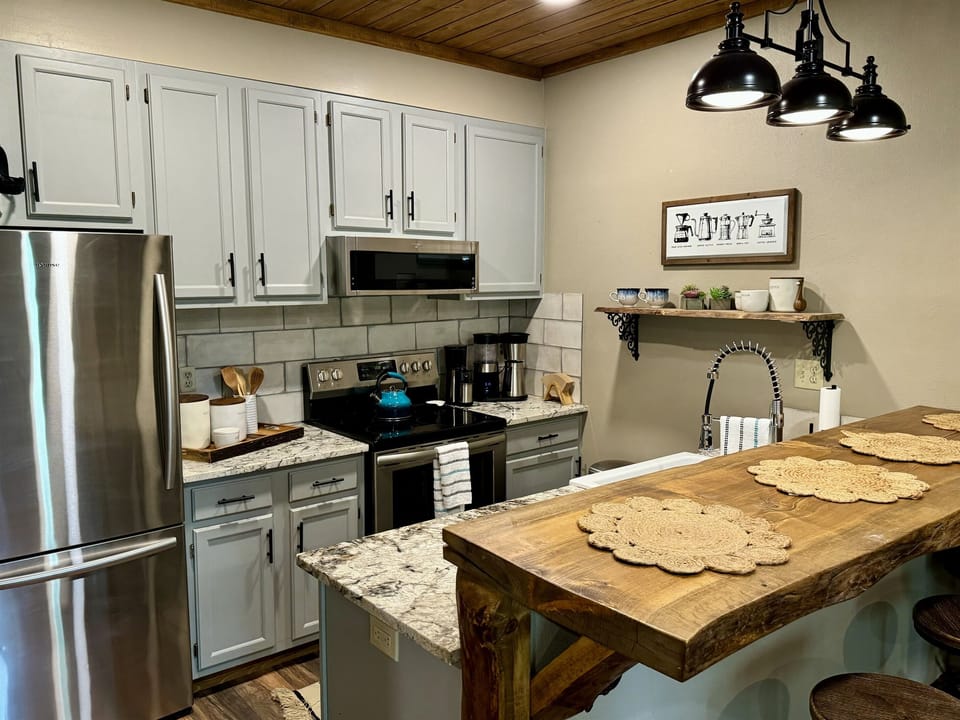 Full size refrigerator, stove, dish washer and gourmet coffee maker.