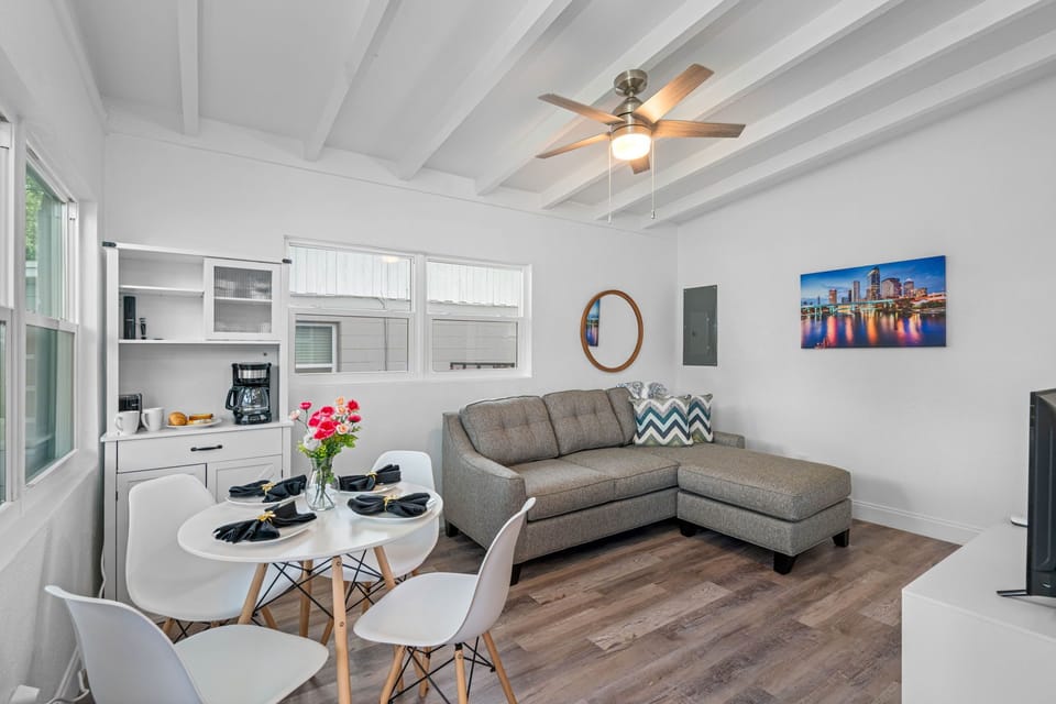 During the day, natural light floods in through large windows, illuminating the room and highlighting its tasteful decor.
