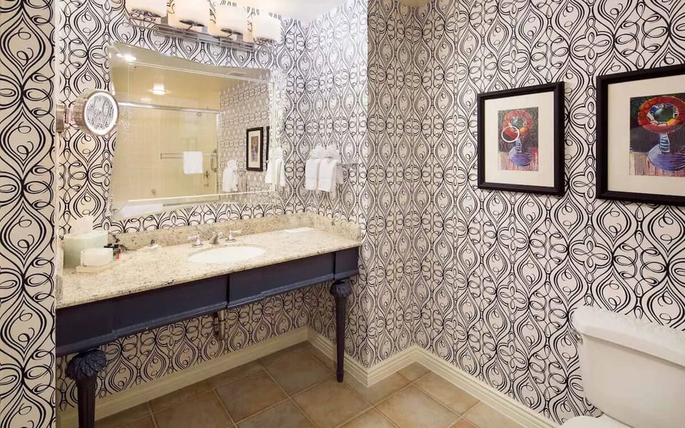 Enjoy a polished bathroom with bold pattern and fresh towels.