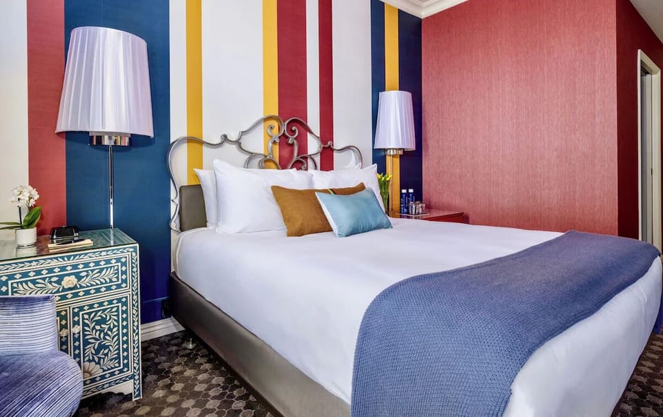 Wake up to soft daylight beside a sleek, practical workspace.