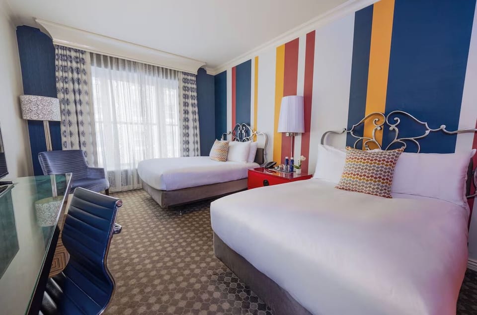 Settle into double beds with crisp linens and playful colors.