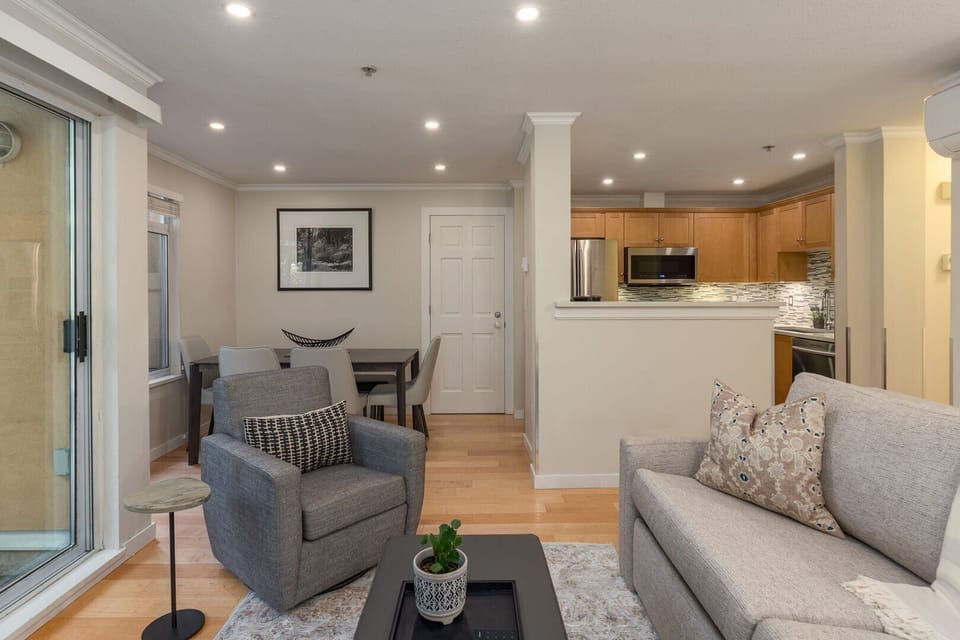 The living room doubles as a sleeping space with a queen-size pullout sofa bed.