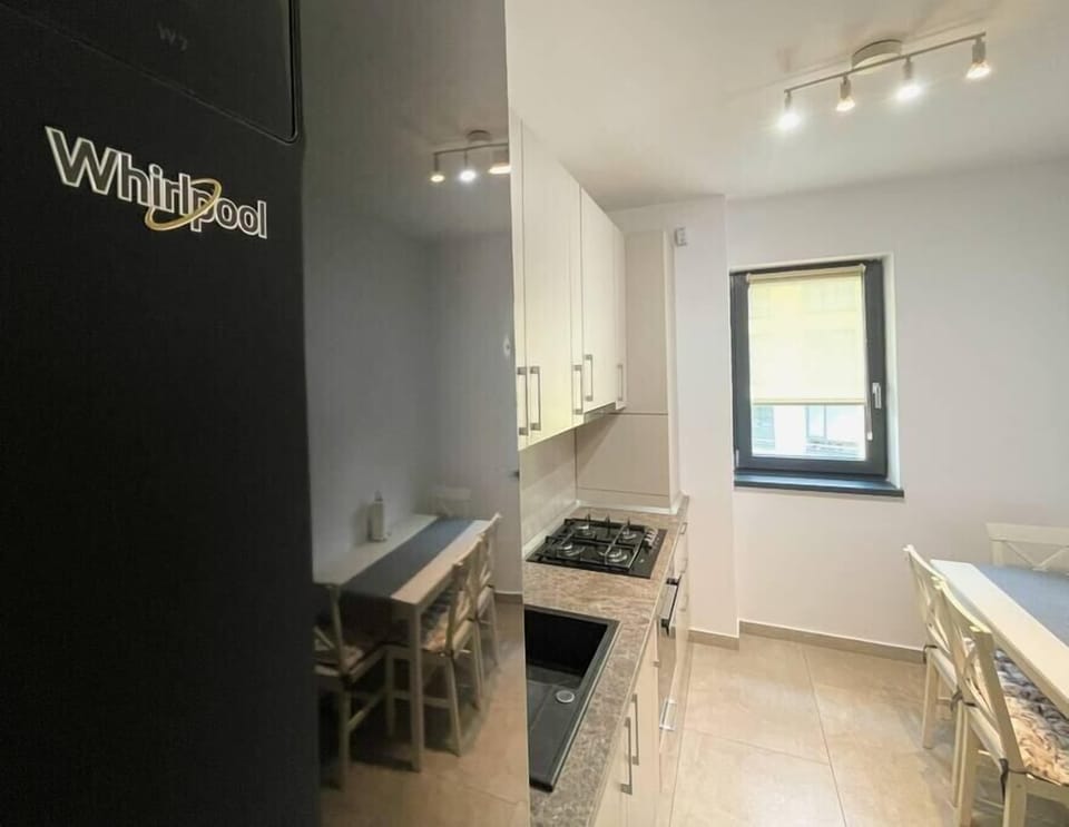 Fully equipped kitchen with huge fridge with freezer that has a water dispenser incorporated, stove, oven, toaster, coffee maker, cutlery, basic condiments and dining table