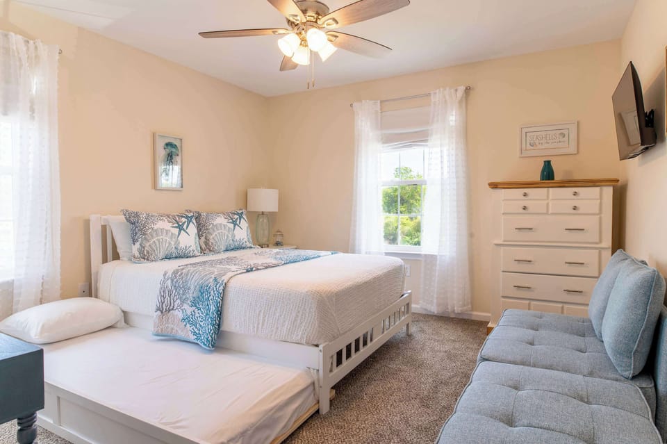 Bedroom 2 with queen bed, twin trundle, pullout chaise chair, and smart tv