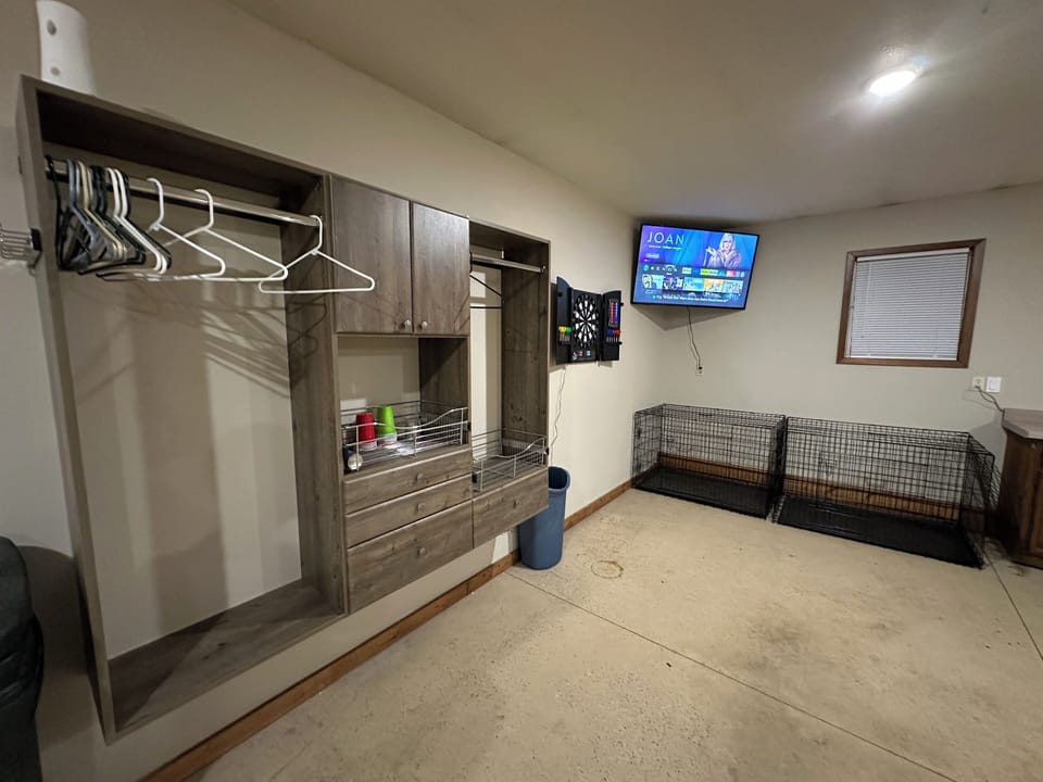 Heated, spacious garage with entertainment, storage, and parking.