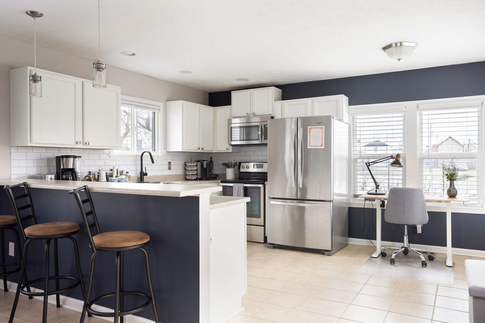 Open concept, fully stocked kitchen with dedicated workspace nearby