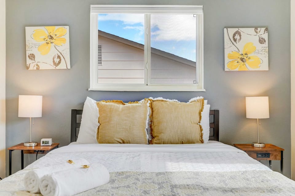 Relax and unwind in this cozy, light-filled bedroom at Quarry Peak, featuring a comfortable queen bed with soft pillows, stylish decor, and a calming ambiance perfect for restful nights.