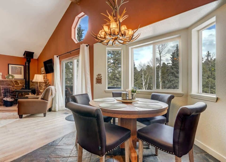 Dine with a view! Our kitchen and dining space opens up to the beauty of the pines, creating the perfect backdrop for your nature feasts.