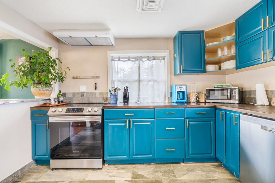 Step into the heart of the home. Our recently remodeled kitchen is accented with a fun bohemian flair, seamlessly blending modern convenience with charming mid-century style.