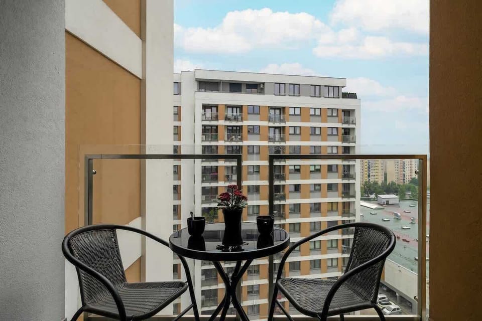 Spacious balcony with outdoor furniture. 