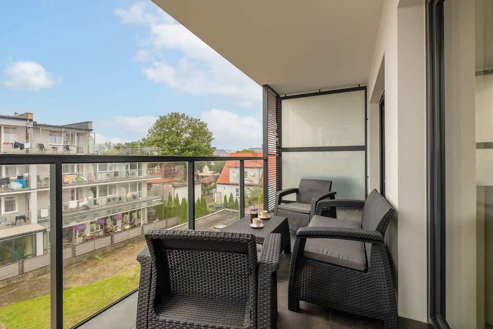 A second balcony view showing modern furniture and a well-designed railing. Great outdoor extension of the living space.