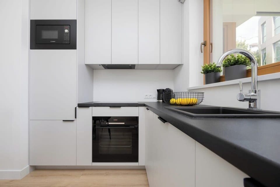 Kitchenette with oven and refrigerator. 