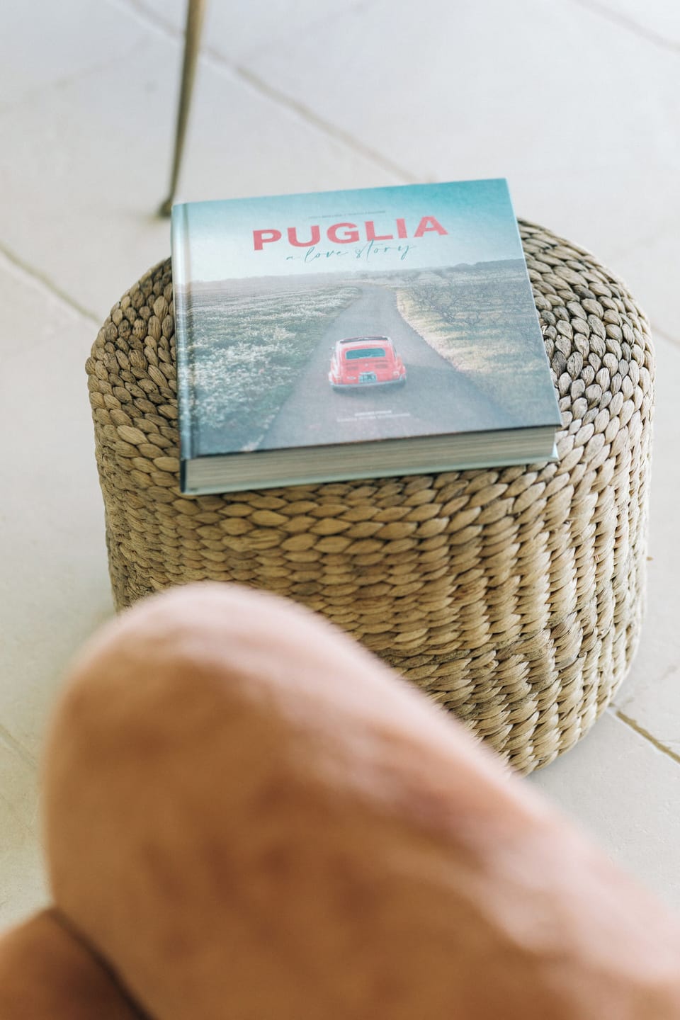 Lifestyle scene featuring a book about Puglia and a car.