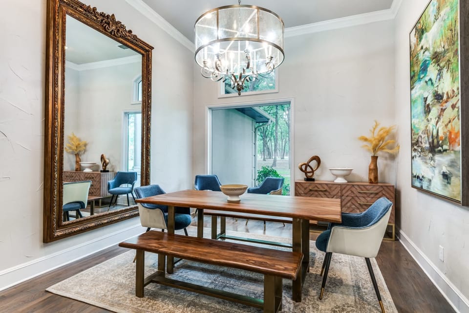 Elegant and chic, this dining room brings the restaurant environment right into your home away from home with the artwork, mirror, and décor. Bon appetit!