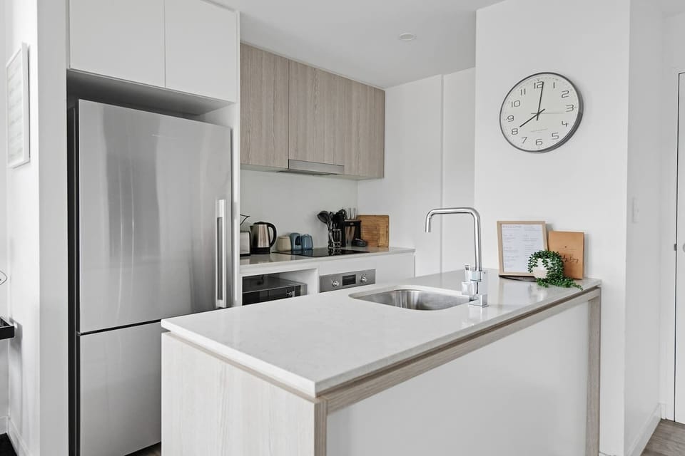 Designed around a central island, the sleek white kitchen comes fully equipped for your holiday catering.
