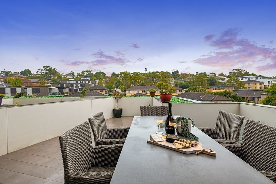 The apartment opens to an expansive deck, perfect for alfresco dining in the crisp coastal air.
