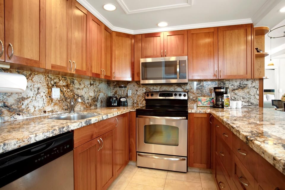 This chef-ready kitchen features granite surfaces, recessed lighting, and all the essentials in polished style    