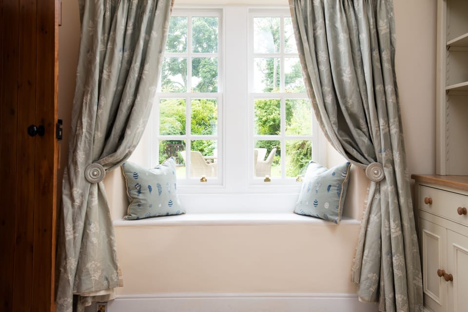 Charming interiors with traditional sash windows, looking out onto front garden