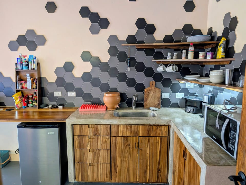 Lots of countertop space, open shelves, outlets, and cabinets & drawers below.