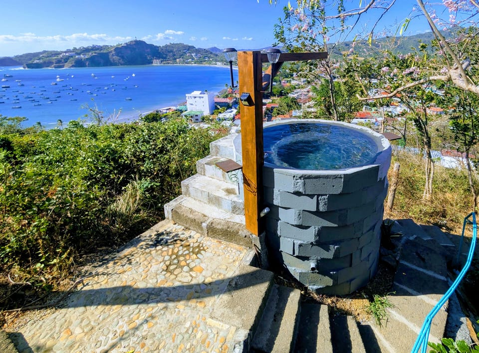 A cozy clearing at the top of our hidden hill is a shared fresh-water plunge-tub