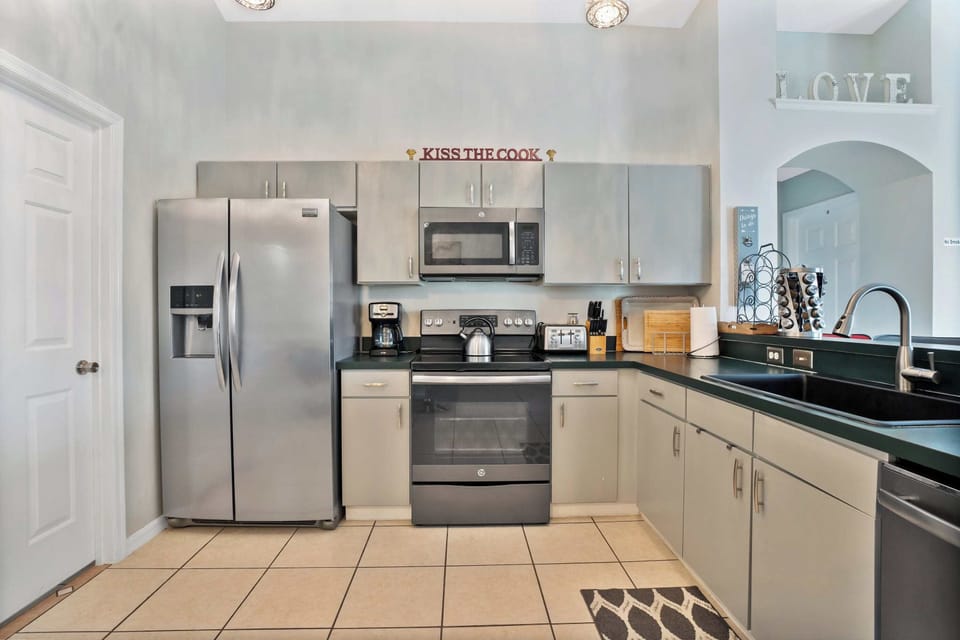 Modern kitchen with stainless steel appliances and ample counter space for cooking.